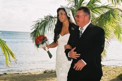 Bride walking in with her daddy, ocean in the background