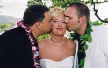 Two guys kissing bride's cheek at the same time