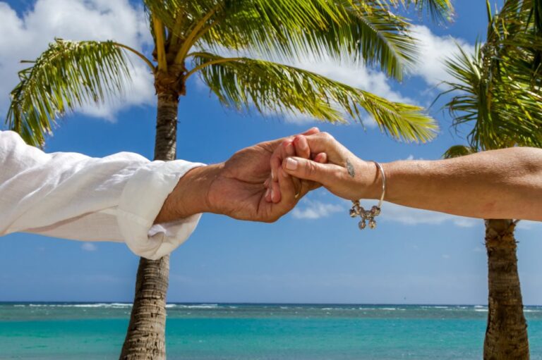 Married hands with ocean and palm backdrop at Waialae beach